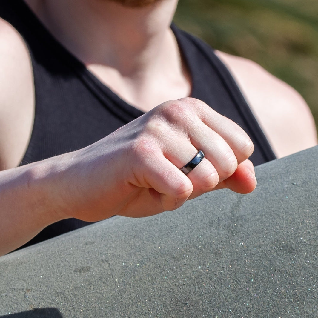 A close up of a persons hand wearing RingPay's Zirconia Ceramic Payment Ring.
